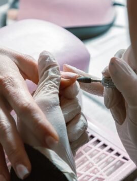 Close-up of a professional manicure process in a nail salon with precision care.